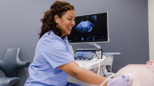 Happy Sonographer Performing Scan